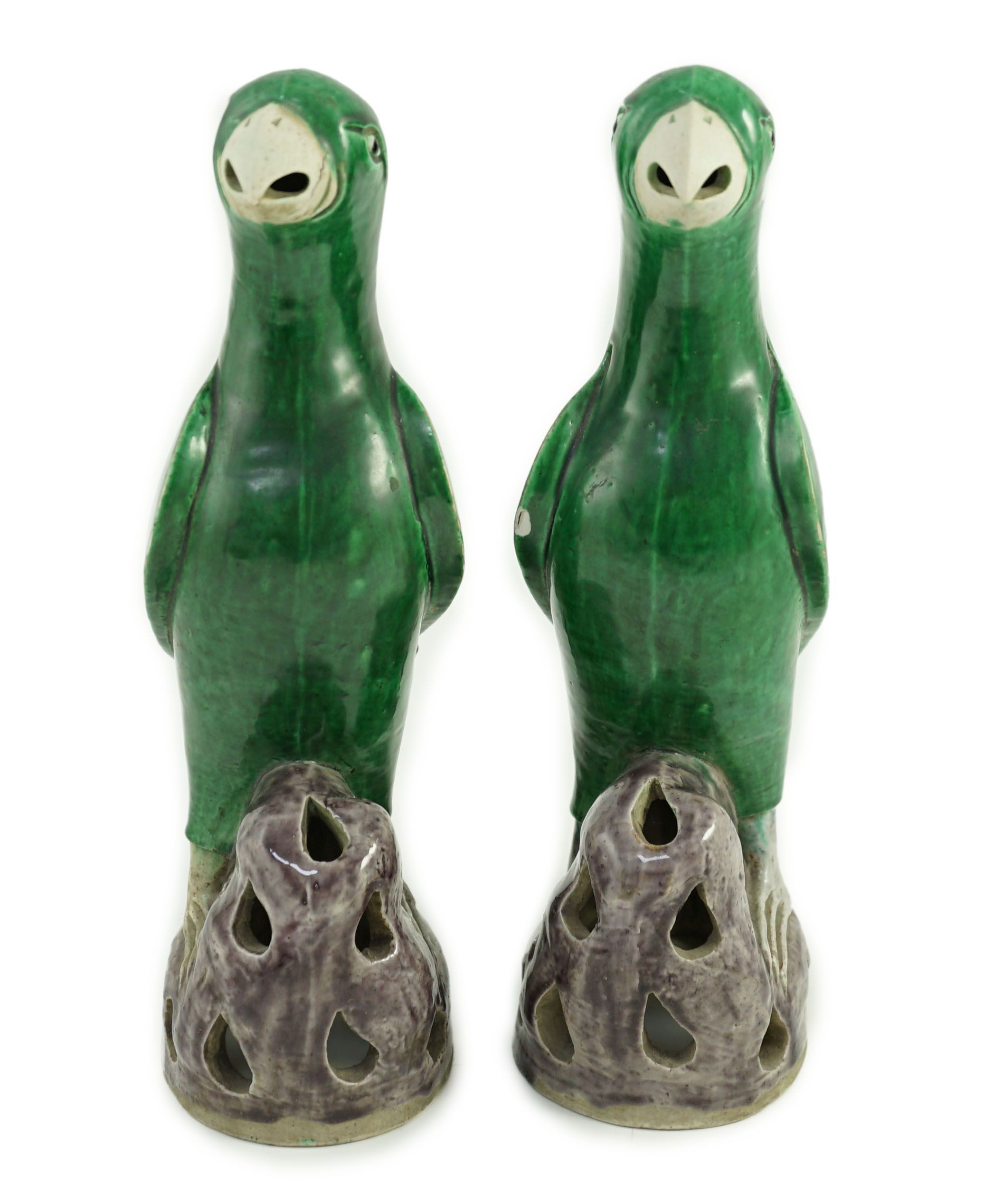 A pair of Chinese green and aubergine glazed models of parrots, 19th century, 27.5cm high